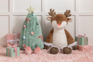 Styled view of Mud Pie jumbo Christmas tree plush with other plush pals