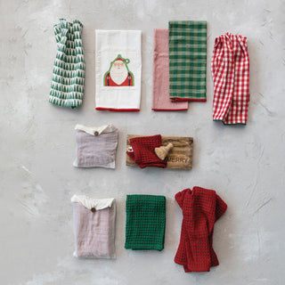 Styled view of set of 3 multi-color woven cotton holiday tea towels, 28 by 18