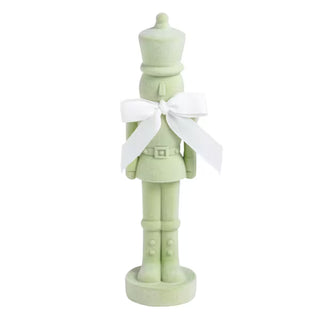 Mud Pie green flocked nutcracker sitter with cotton bow at neck