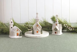 Styled view of Mud Pie double trees church sitter with reactive glaze