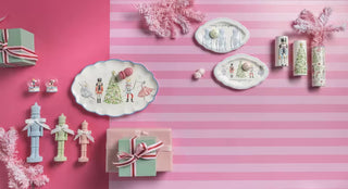 Styled view of Mud Pie pink nutcracker sitter with holiday accents