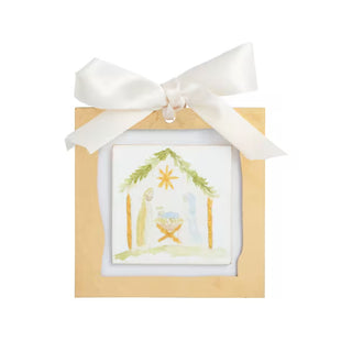 Styled view of Mud Pie gold acrylic ornament with hand-painted paper accents