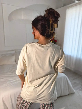 Styled view of cream 90s Christmas graphic tee