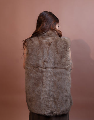 Back view of brown sugar faux fur vest with sleeveless cut
