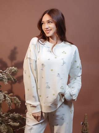 Side view of martini motif crew neck top showing relaxed dropped shoulders