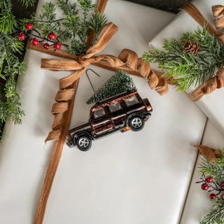 Brown SUV with Christmas tree ornament for nostalgic holiday decorating