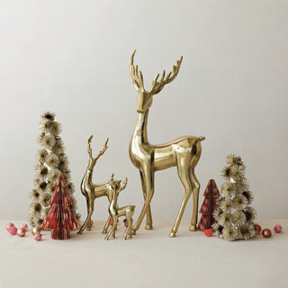 Styled view of cast aluminum deer figurine with radiant gold finish