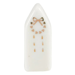 Close-up of ceramic house figurine with gold foil embellishment
