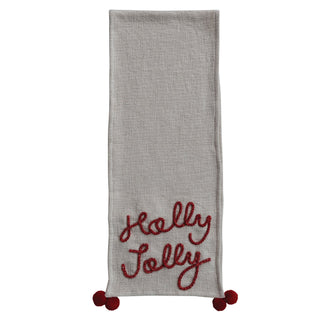 Cotton slub table runner with red Holly Jolly embroidery and pom-pom corners