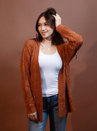 Rust cable knit cardigan with open front and longer hip length