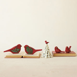 Hand-painted red ceramic bird figurine with embossed green botanical detail