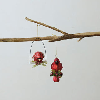 Hand-painted mercury glass cardinal ornament perched on a holly branch
