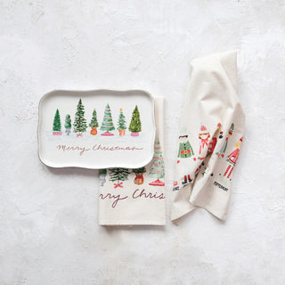 Scalloped stoneware platter with evergreen trees and gold Merry Christmas lettering