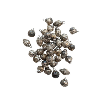 Close-up of embossed mercury glass holiday ornaments