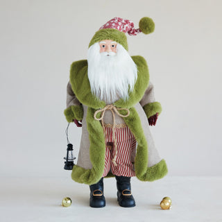 Fabric and faux fur Santa in green coat holding a miniature lantern