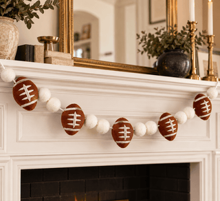 Six-foot football garland alternating footballs and white felt balls for game day
