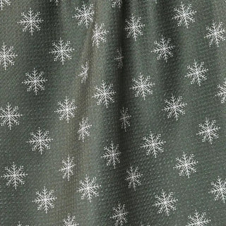 Snowy holiday tea towel draped over an oven handle