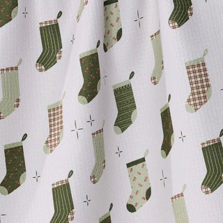 Stocking Medley Christmas tea towel draped in a festive kitchen