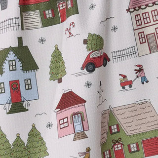 Styled view of Winter Village print tea towel in quick-drying recycled woven fabric