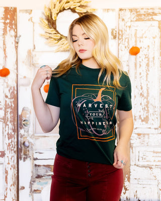 Close-up of Harvest Your Happiness graphic on green tee
