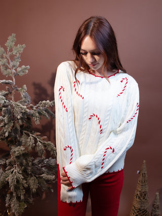 Detail view of ivory and red cable knit texture on Hem & Thread sweater