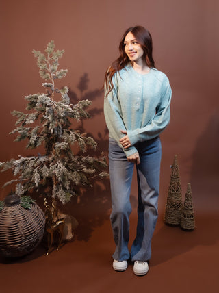 Styled view of Hem & Thread sage Henley sweater with button-up front and raglan sleeves