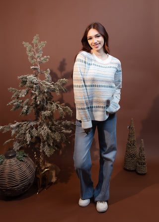 Close-up of the snowy village Fair Isle pattern on Hem & Thread sweater