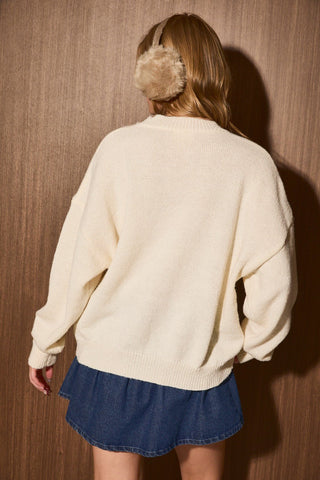 Detail view of Meet Me at the Lodge embroidery with ribbed crew neck