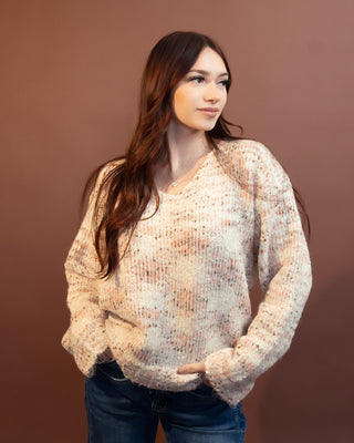 Close-up of the speckled bouclé-inspired knit texture on the ecru sweater