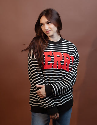 Styled view of black and white striped cloud knit top with festive Merry graphic