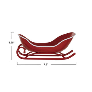 Side view of red and white sleigh-shaped metal soap dish