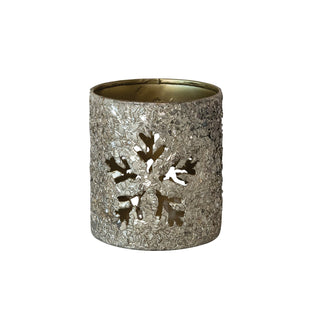 Snowflake cut-out votive holder glowing with a lit candle