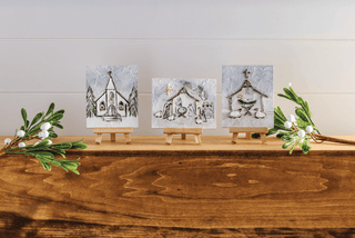 Styled view of Mud Pie nativity wall art in a clean modern farmhouse style