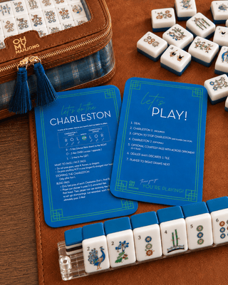 Set of two blue mahjong tile shufflers with rules printed on the sides