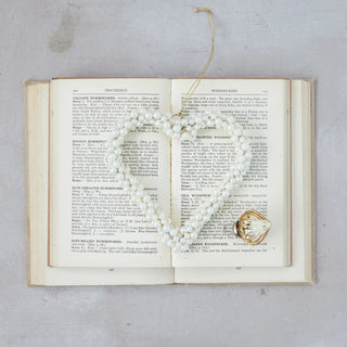 Close-up of glossy faux pearls on heart-shaped Christmas ornament