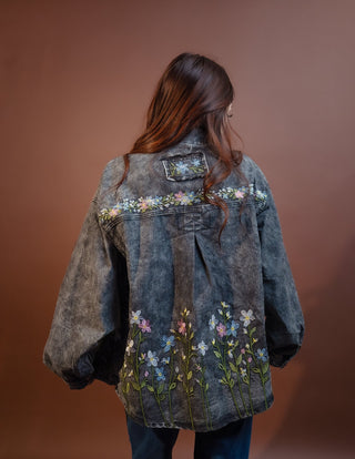 Close-up of embroidered florals on POL black mineral wash denim