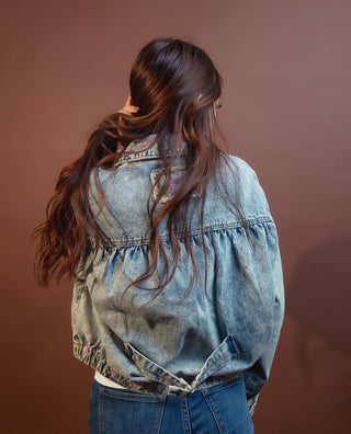 Close-up of POL denim floral print and zip front closure