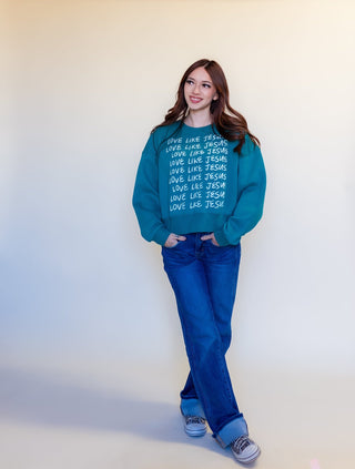 Detail view of Love Like Jesus graphic on teal sweatshirt