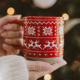 Red glazed stoneware coffee mug with embossed snowflake and deer Fair Isle pattern
