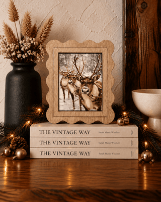 Reindeer trio Christmas canvas art in a scalloped stained wood frame
