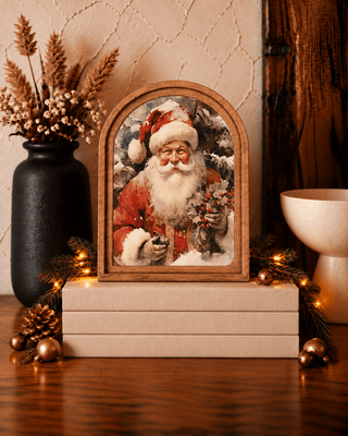 Santa with holly Christmas arch canvas art in a stained wood frame