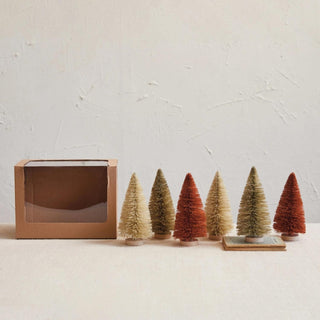 Styled view of light grey bottle brush trees in holiday decor