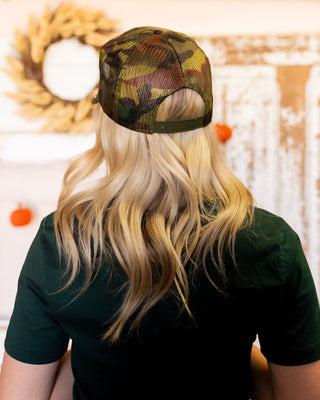Front view of People Give Me the Creeps camo trucker hat