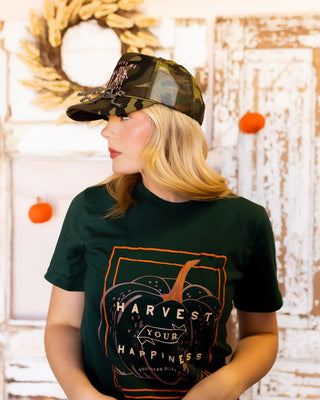 Skelly camo trucker hat shown in one of two skeleton pin finishes