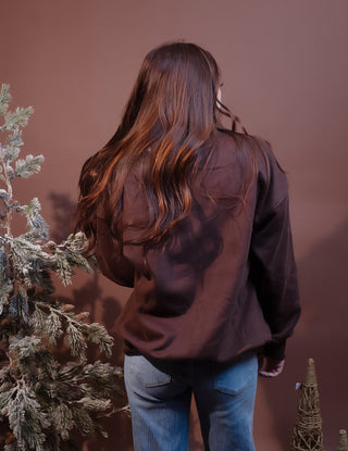 Detail view of the cozy mock neckline and ribbed knit trim