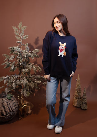 Close-up of corgi graphic with red paisley bandana on navy sweater