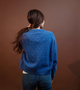 Side view of drop-shoulder eyelet knit cardigan with oversized button details