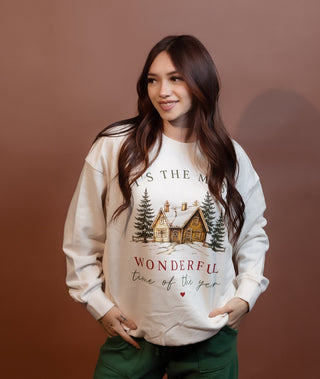 Detail view of Most Wonderful Time Of The Year graphic on ivory sweater