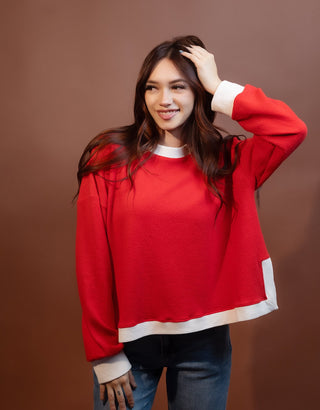 Side view of long sleeve knit top with round neckline