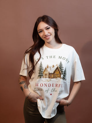 Close-up of festive lettering on ivory holiday graphic tee